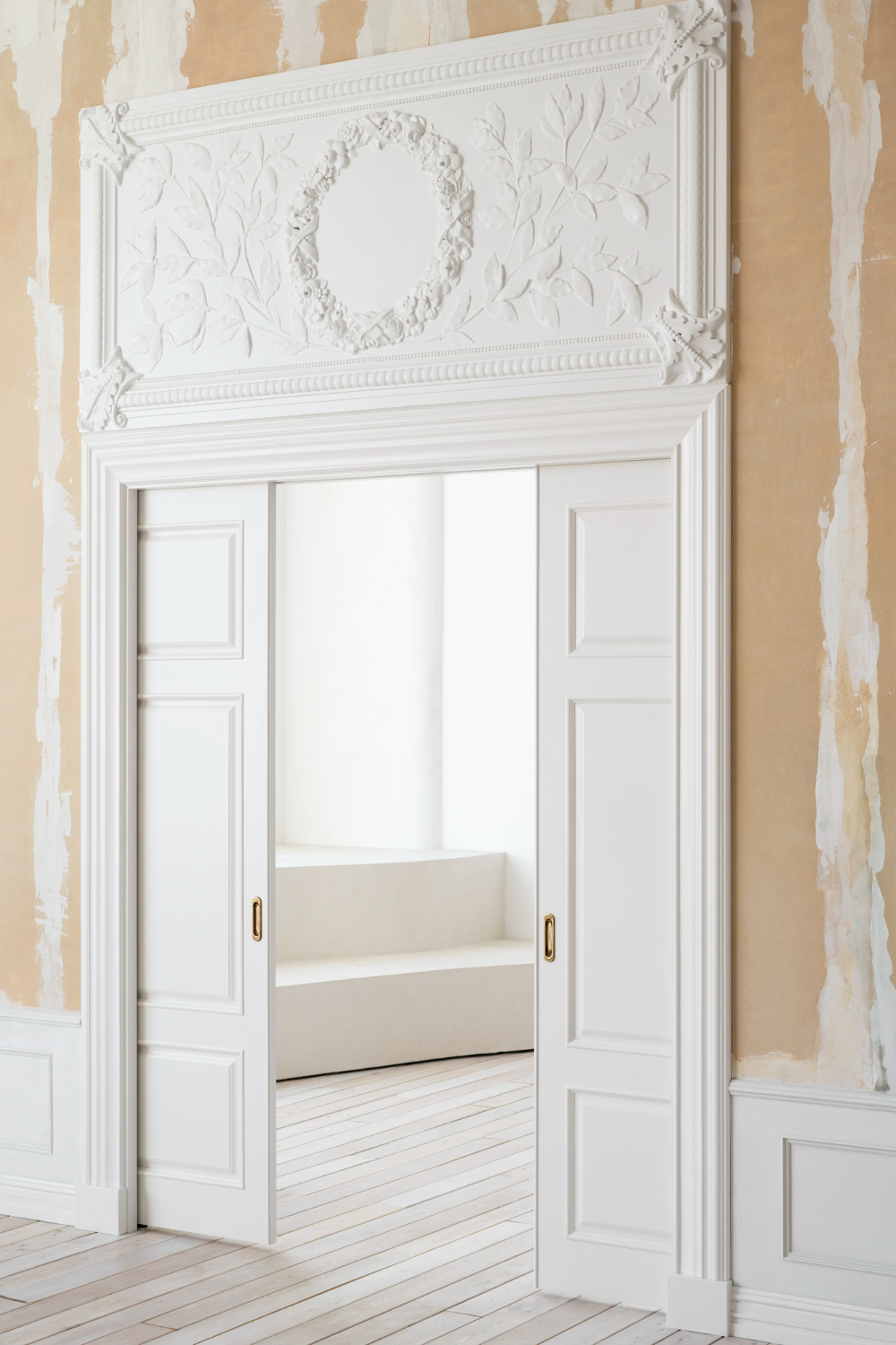 Bright interior doorway framed with classic mouldings